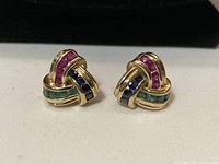 Front view of earrings showing knot design and coloured gemstones