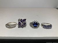 group shot of four sterling silver rings