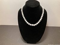 Necklace displayed on bust form showing overall appearance and graduation of beads