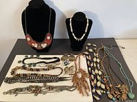 All jewelry pieces laid out including two display stands