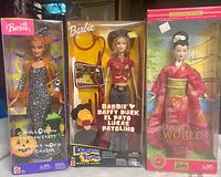 Front view of all three boxed Barbie dolls