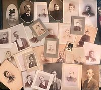 All 32 mounted portraits spread out to show variety of subjects and mount styles