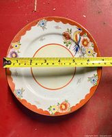 Single plate with tape measure showing 7 in diameter, illustrates pattern and size