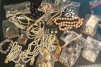 Overview of entire jewelry lot on black surface