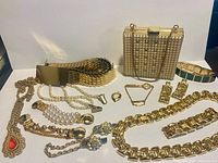 Wide shot of all jewelry, belt, purse displayed