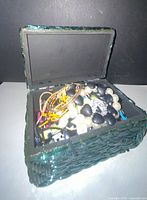 open green glass mosaic jewelry box filled with assorted jewelry