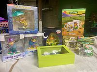 Group shot of all boxed Nickelodeon items including four vinyl figures, glass mug, tea strainer, Nick Box