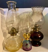 Three oil lamps side by side showing overall condition and colors
