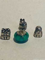 Front view of four Pandora charms showing shapes and colours