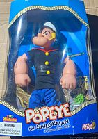Front of sealed Mezco Popeye the Sailorman action figure in window box