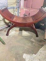 full view of curved wood bench showing shape and legs