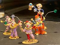 Front view of all six enameled pewter clowns