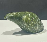 Left profile of polished green soapstone bird sculpture