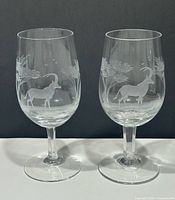 Front view of both engraved crystal wine glasses