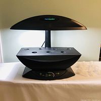 Front view of AeroGarden unit showing canopy, grow deck and accessory domes