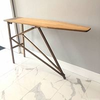 Full view of wooden ironing board folded open