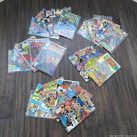 All 27 comics fanned in three groups on floor