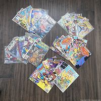 All 26 bagged comic books spread out on floor