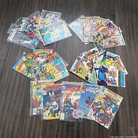 All 26 comic books laid out showing fronts and plastic sleeves