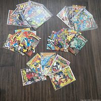 All 26 comics spread on floor showing variety of titles and condition