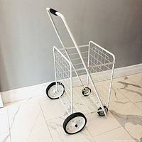 Full view of white folding grocery cart, side profile