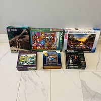 All seven boxed puzzles arranged; shows fronts and relative sizes