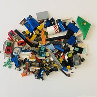 Spread of mixed LEGO pieces showing variety of parts and colours