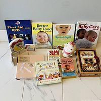 Group shot showing all books, piggy bank, photo album, keepsake box, musical frame