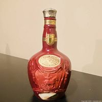 Full view of ruby red Royal Salute porcelain bottle with stopper