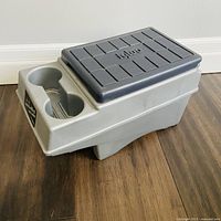 Angled view of complete cooler showing body, flip-top lid and cup holders