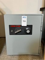 Front view of closed Fire Fyter safe showing logo, handle and combination dial.