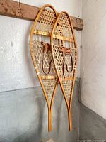Full view of both snowshoes hanging side by side