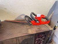 Full view of Black & Decker corded hedge trimmer on shelf