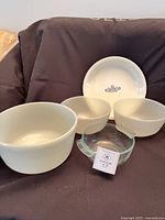 All five pieces displayed: three white Fire King bowls, white Corning Ware pie plate, clear Pyrex bowl