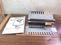 kit laid out with jig body, clamp bar, spacer and manual