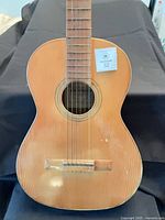 Front view of Jose Morales classical guitar, visible wear on soundboard