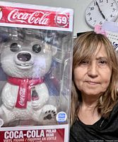 Front view of boxed jumbo Funko Pop Coca-Cola Polar Bear beside person for scale