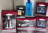 Group shot of five ornament boxes showing Janeway, Enterprise, one Action Comics, and two Superman lunchbox boxes