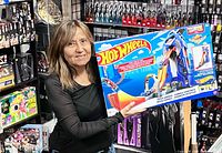 Front of sealed Hot Wheels City Mega Garage box held by person, showing branding and contents