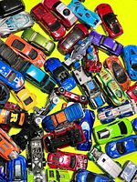 Top view of densely packed assorted diecast cars displaying colour variety