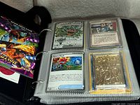Open binder showing assorted cards including Mabosstiff ex, Trainer card, gold-tone card