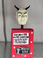 Front view showing entire bobblehead with text panel and devil head