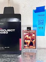 Card in acrylic case next to Project 2020 sleeve