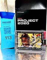 Card in acrylic case beside Project 2020 box