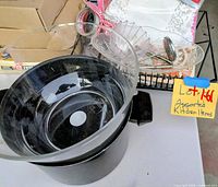 Overall view showing pot, plastic bowl inside, drying rack with assorted items