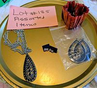 Overview on tray showing necklace, cuff bracelet, earrings, studs