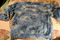 Back view of blue Stitch graphic sweatshirt laid flat