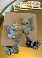 Butterfly rhinestone earrings on card and bar-shaped brooch