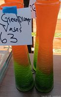 Two identical green-to-orange textured glass vases standing upright