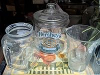 Group shot showing Hershey's cookie jar with lid and two clear glass pitchers
